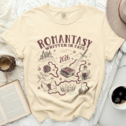 Cream comfort colors t-shirt with romantasya design featuring castle, sword, books, rose, crown, and potion.