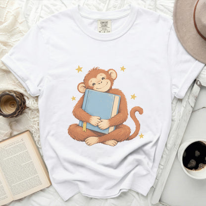 Illustration of a happy monkey hugging a blue book with yellow stars.