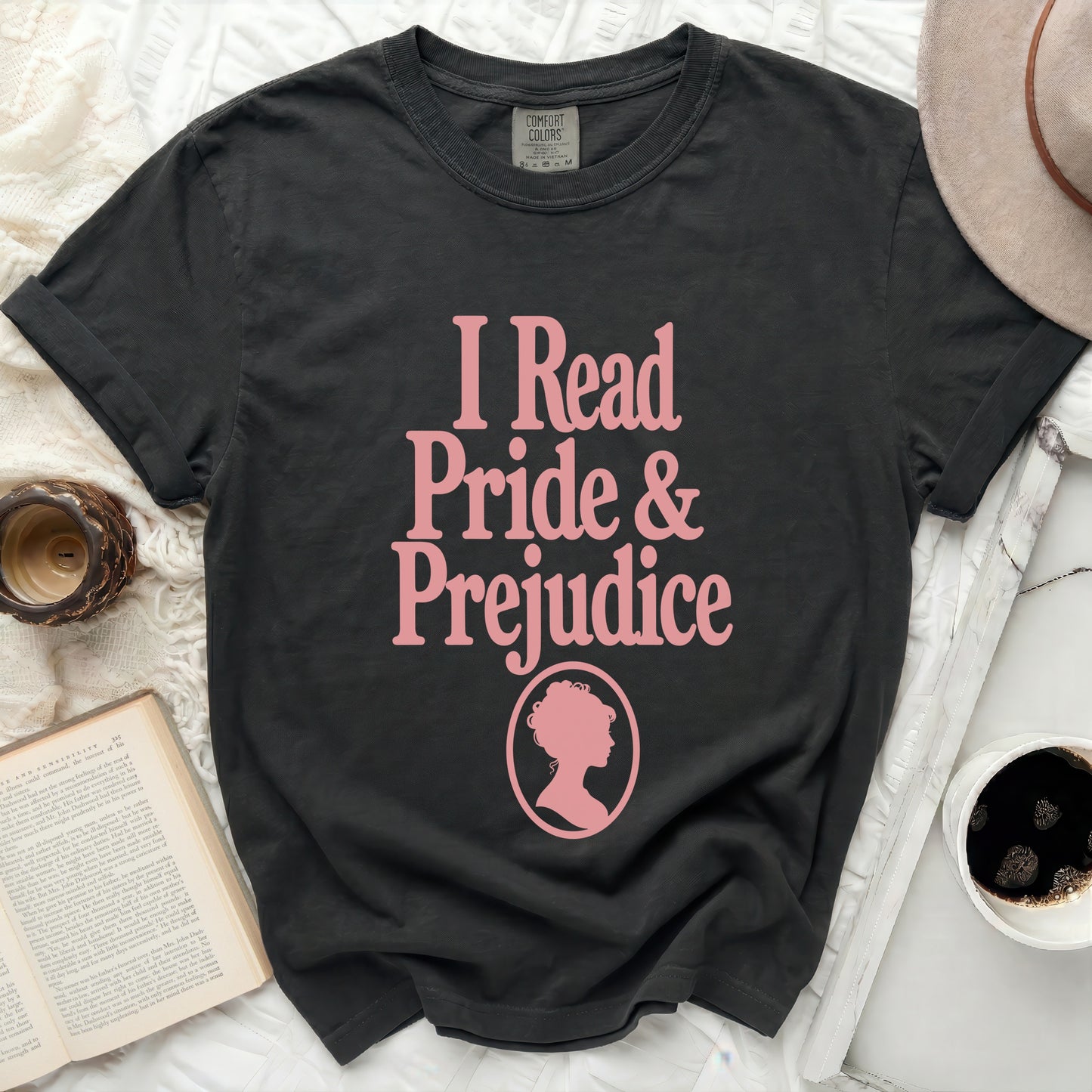 Dark grey t-shirt with pink text "I Read Pride & Prejudice" and silhouette.