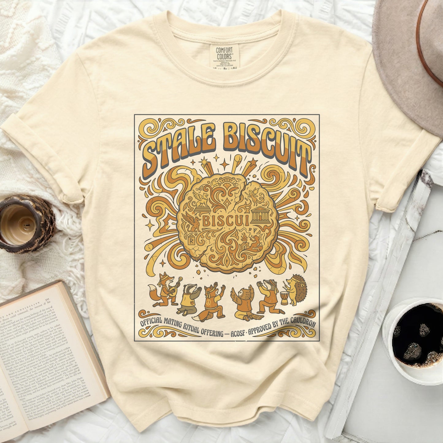 Cream t-shirt with "Stale Biscuit" and forest animals graphic.