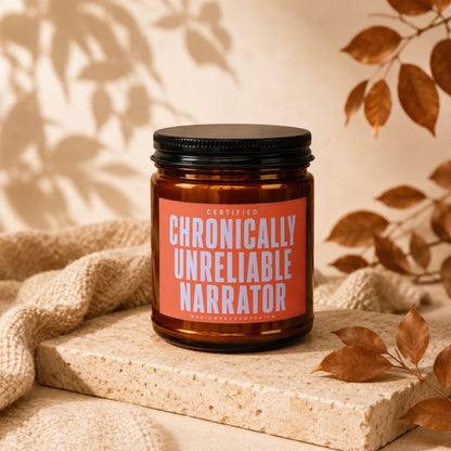 Amber jar candle with orange label reading "Certified Chronically Unreliable Narrator."