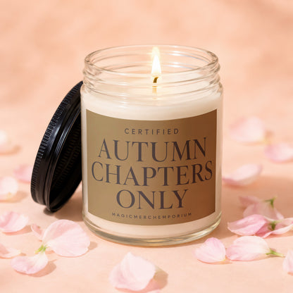 Lit glass candle with lid off, reads "Certified Autumn Chapters Only".