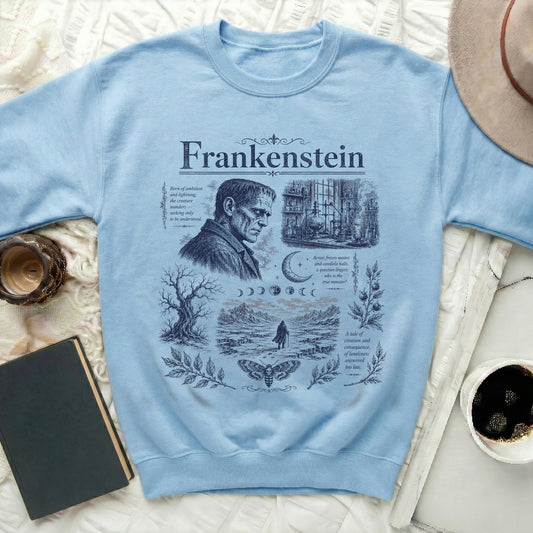 Light blue sweatshirt with Frankenstein collage including text and illustrations.