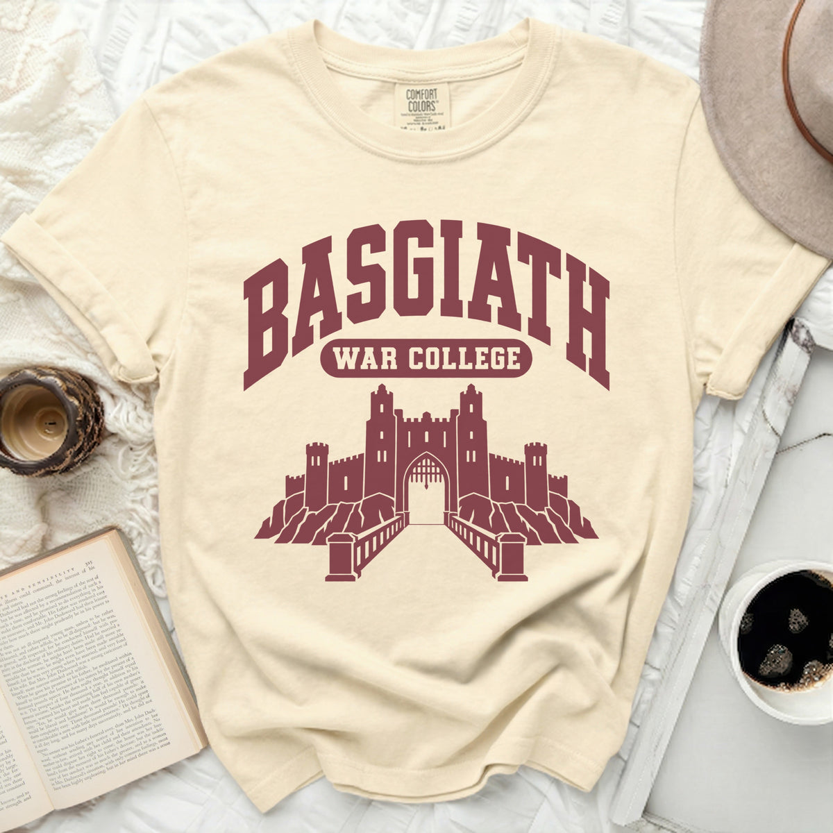 Cream t-shirt with maroon BASGIATH WAR COLLEGE text and castle graphic.