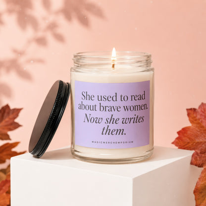 Candle with text "She used to read about brave women. Now she writes them."