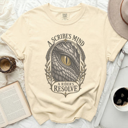Cream t-shirt with a dragon's eye and "A Scribe's Mind, A Rider's Resolve" text.