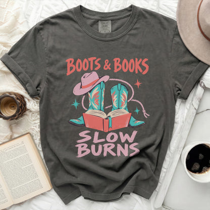 Graphic t-shirt with "Boots & Books Slow Burns" text, cowboy boots, and hat.