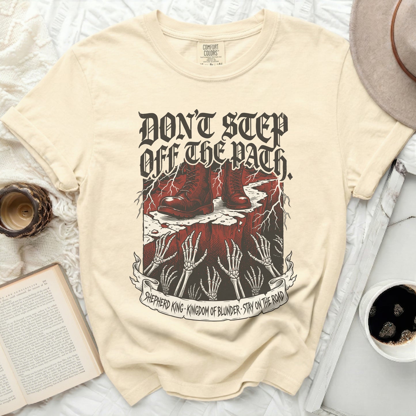 Cream t-shirt with "Don't Step Off The Path" text and graphic.