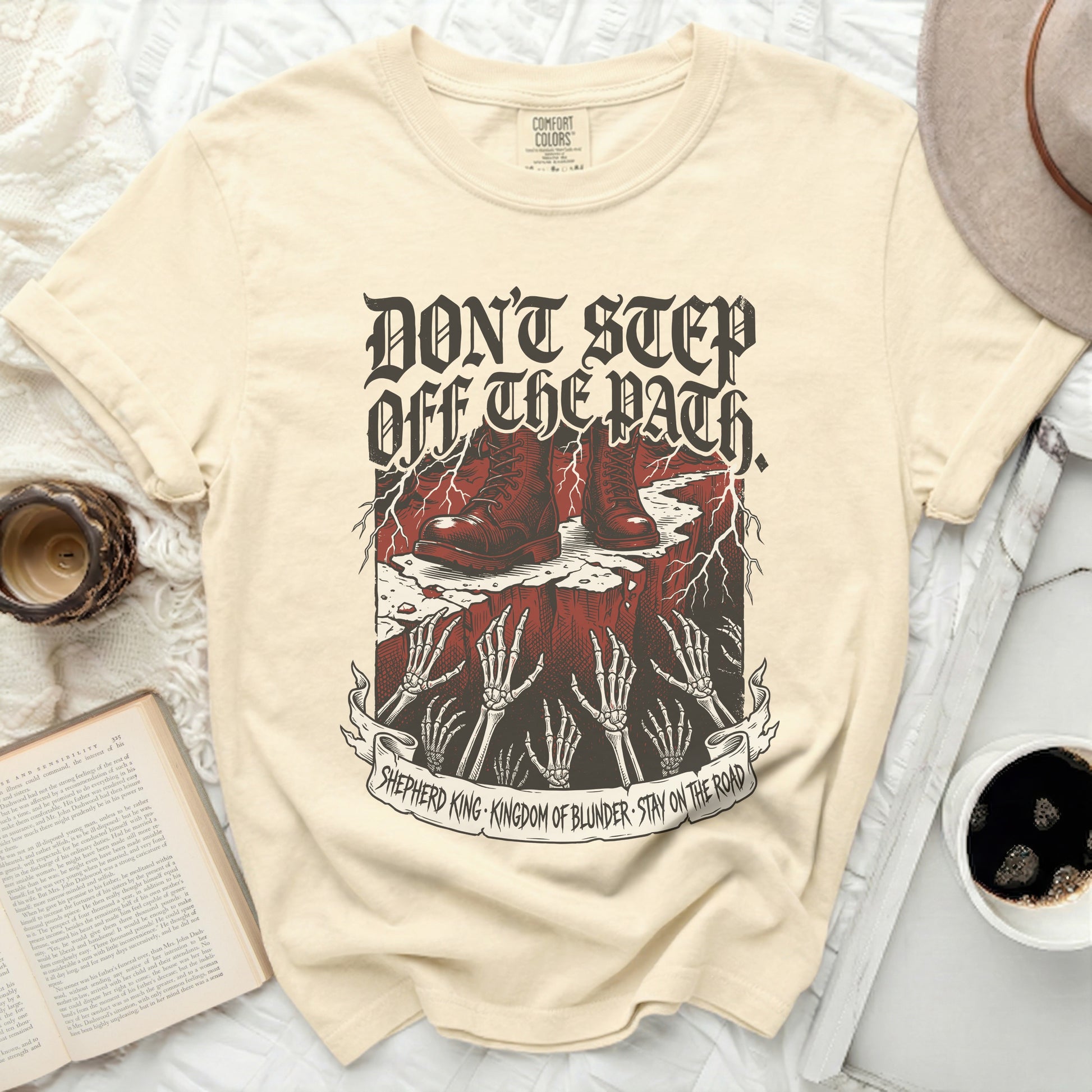 Cream t-shirt with "Don't Step Off The Path" text and graphic.