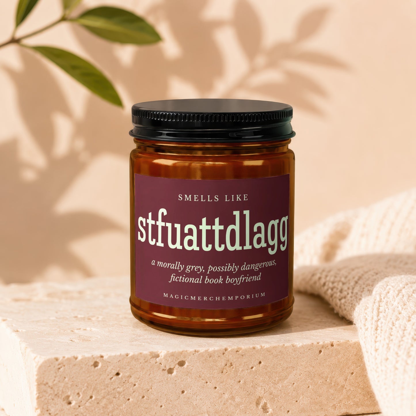 Amber jar candle labeled "stfuattdlagg": a morally grey, dangerous, fictional book boyfriend.