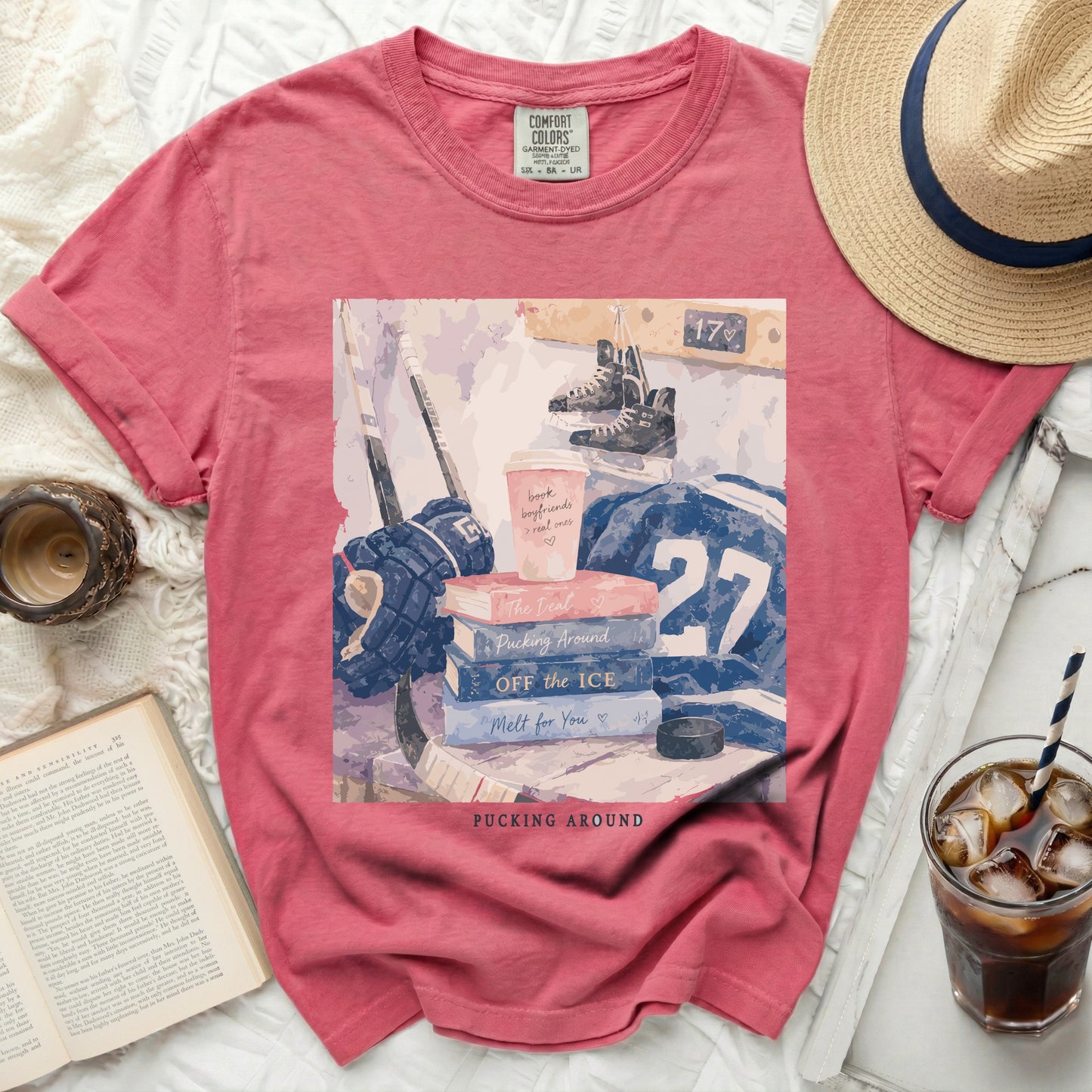 T-shirt with hockey gear, books, and "Pucking Around" text.