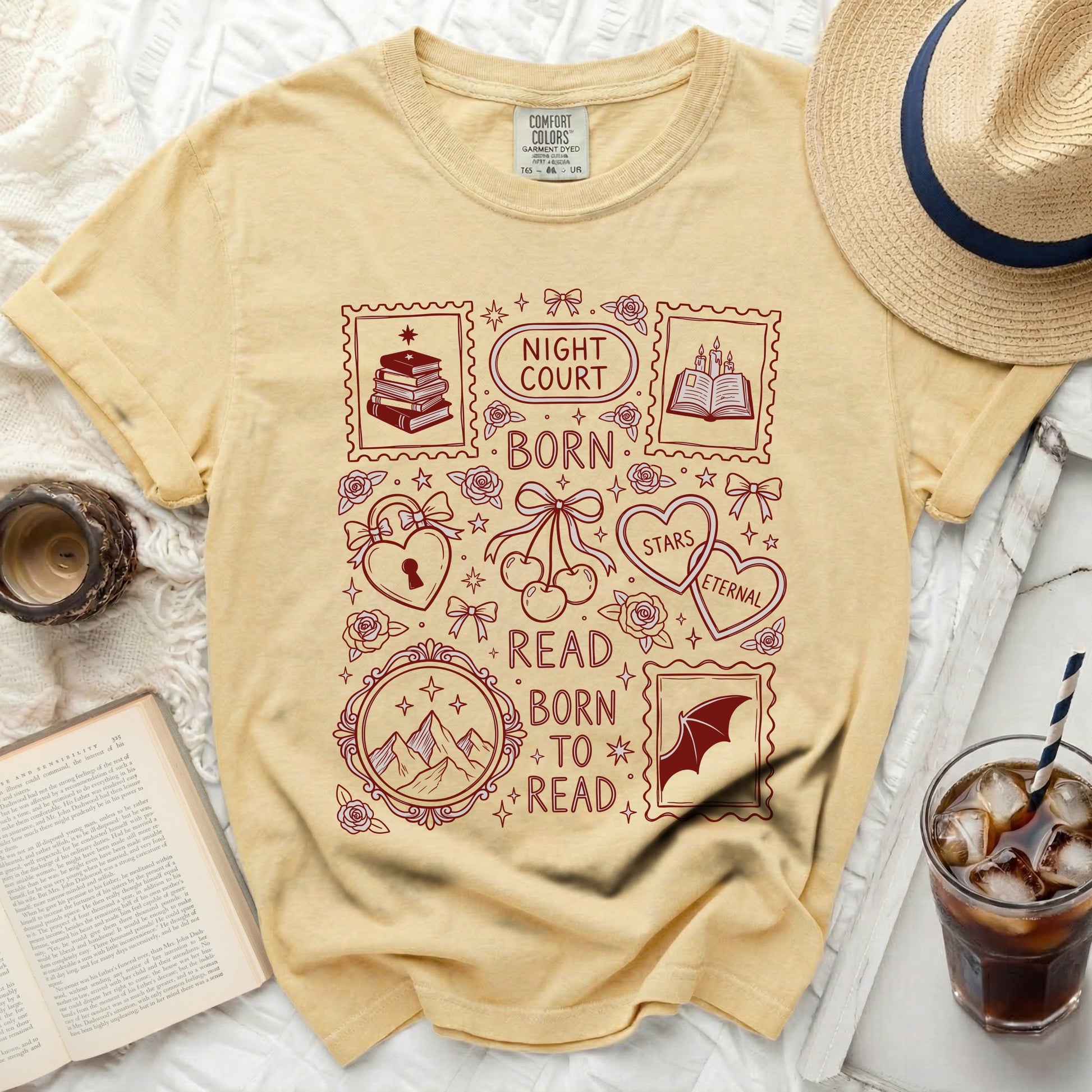 Yellow t-shirt with dark red graphic of postage stamps, books, hearts, and text.