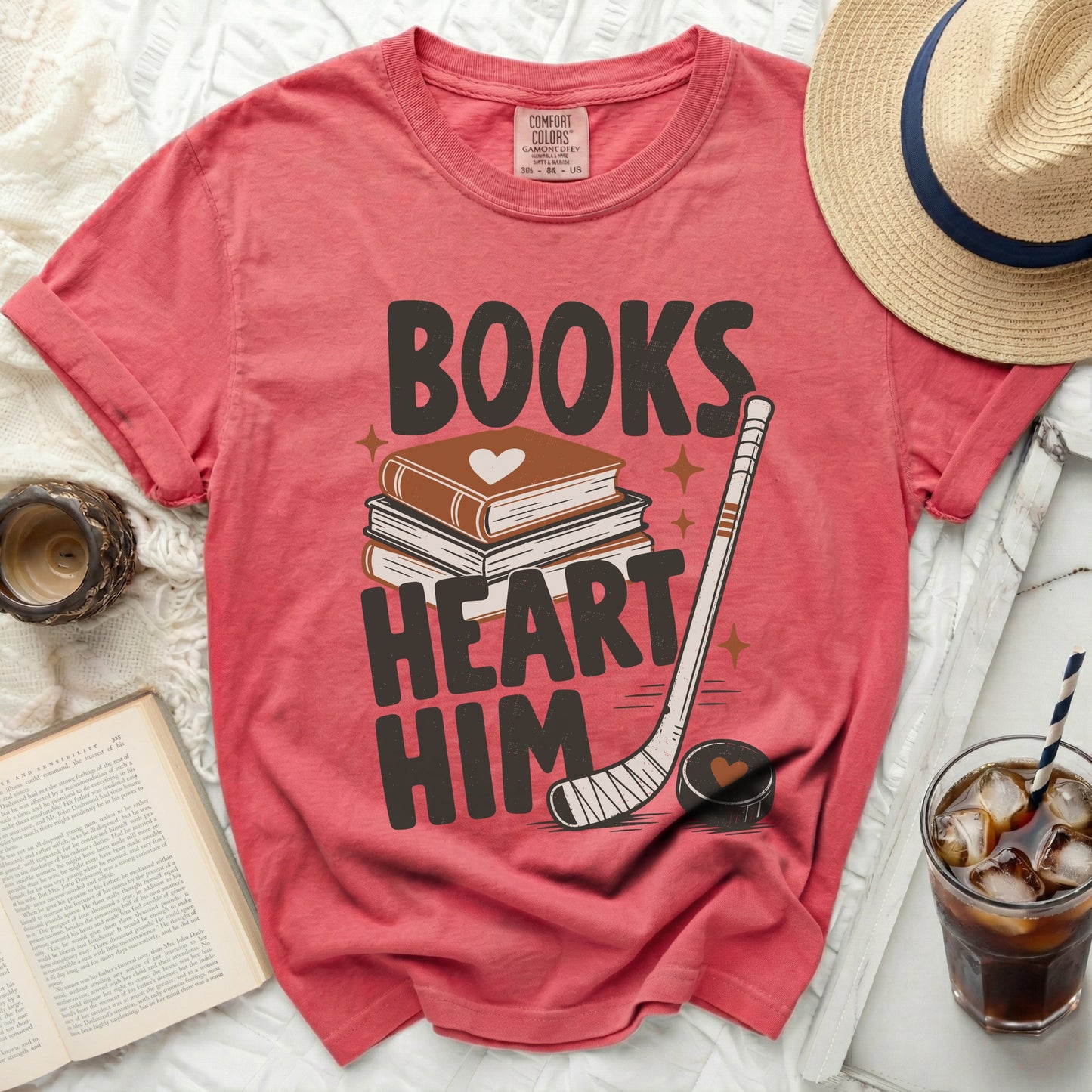 T-shirt with "Books Heart Him" text, books, and hockey stick.