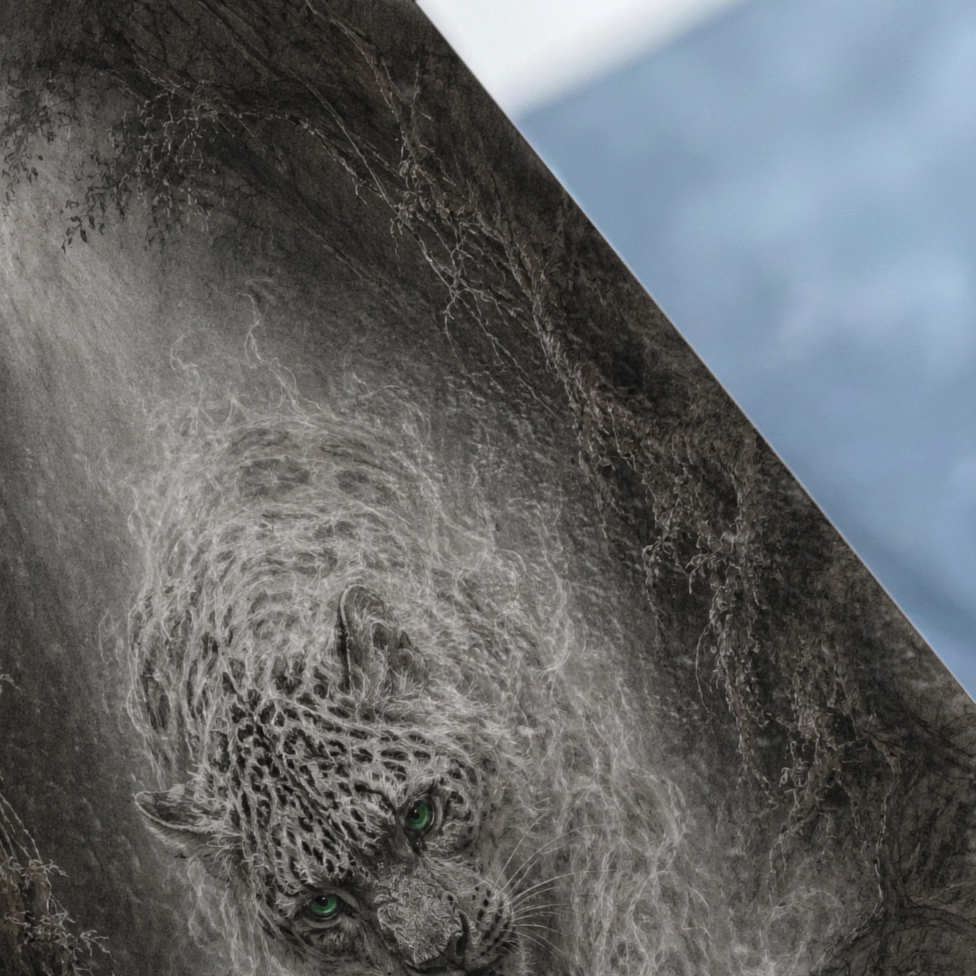 Detailed grayscale drawing of a snow leopard with bright green eyes emerging from misty foliage.