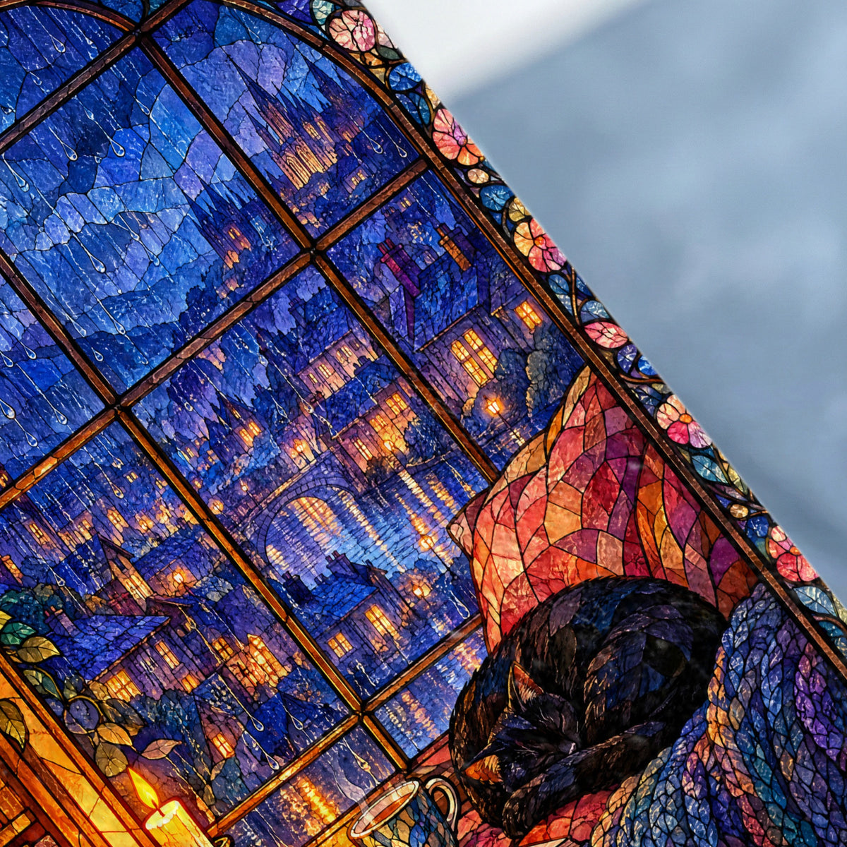 A black cat sleeps curled up beside a stained glass window depicting a city at night.