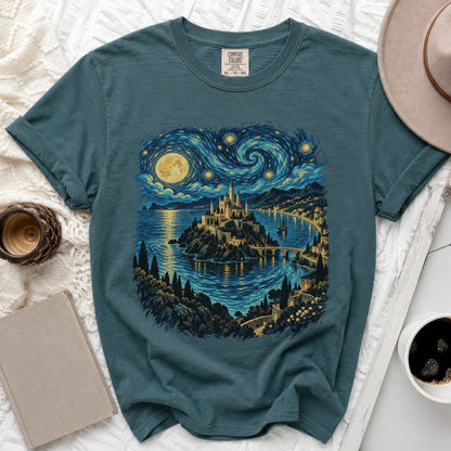 Teal t-shirt with a starry night castle and coastal village graphic.
