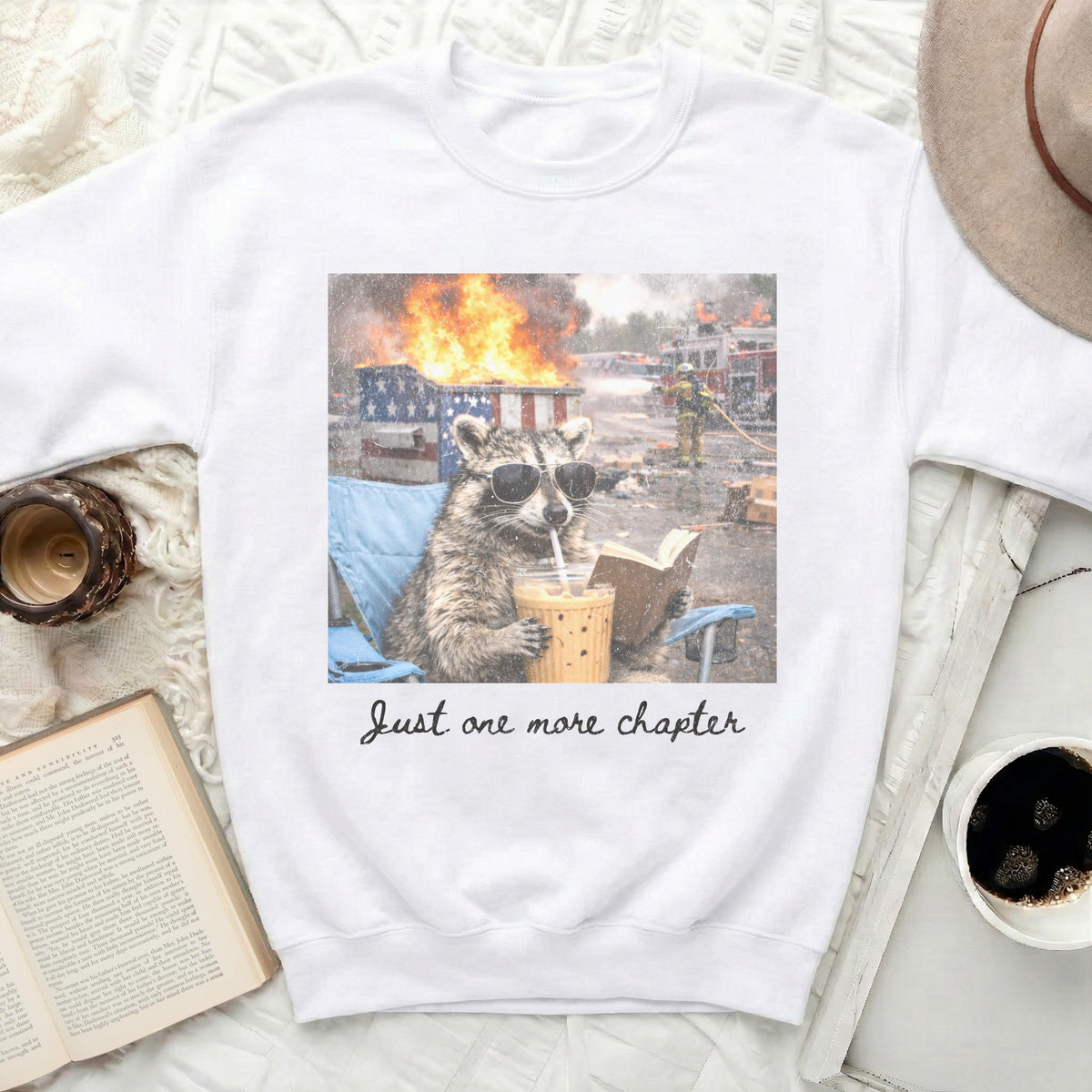 Raccoon wearing sunglasses drinks iced coffee with "Just one more chapter" text.