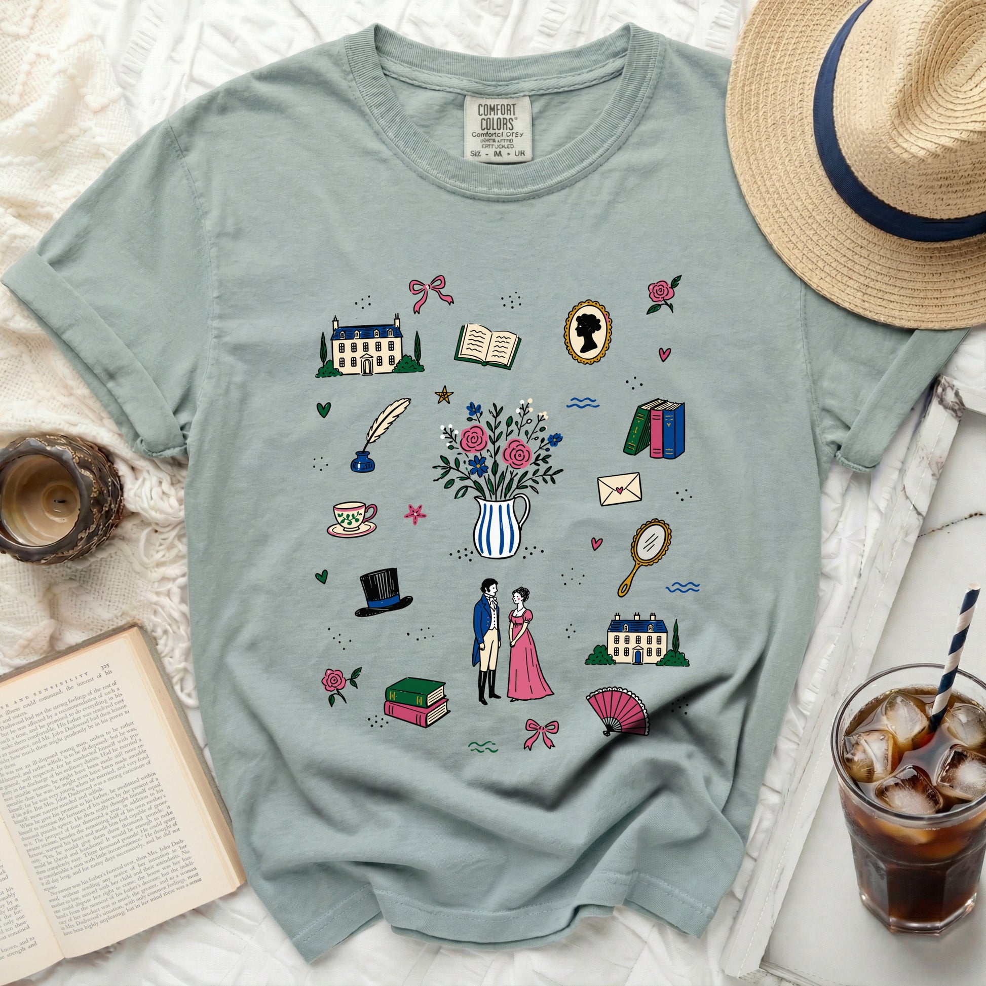 Light blue t-shirt with an illustration of early 19th-century romantic scenes and objects.