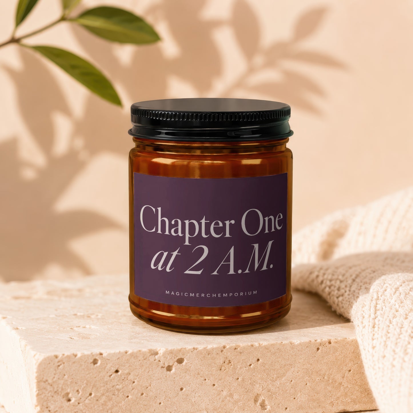 Amber candle with a dark purple label reading "Chapter One at 2 A.M."