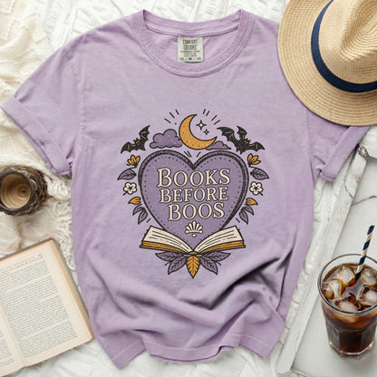 Purple t-shirt with "Books Before Boos" graphic featuring bats, moon, and an open book.
