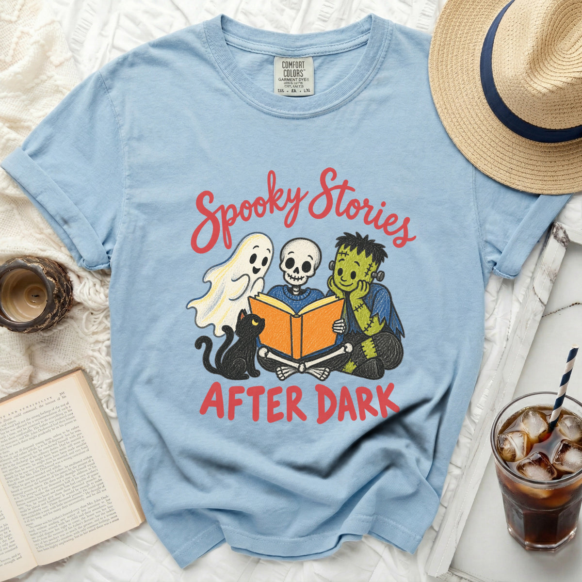Light blue t-shirt with "Spooky Stories After Dark" text and cartoon ghost, skeleton, monster, cat.