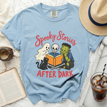 Light blue t-shirt with "Spooky Stories After Dark" text and cartoon ghost, skeleton, monster, cat.