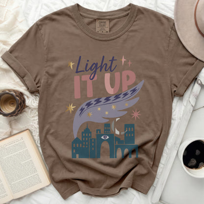 Brown t-shirt with "Light IT UP" text and city design.