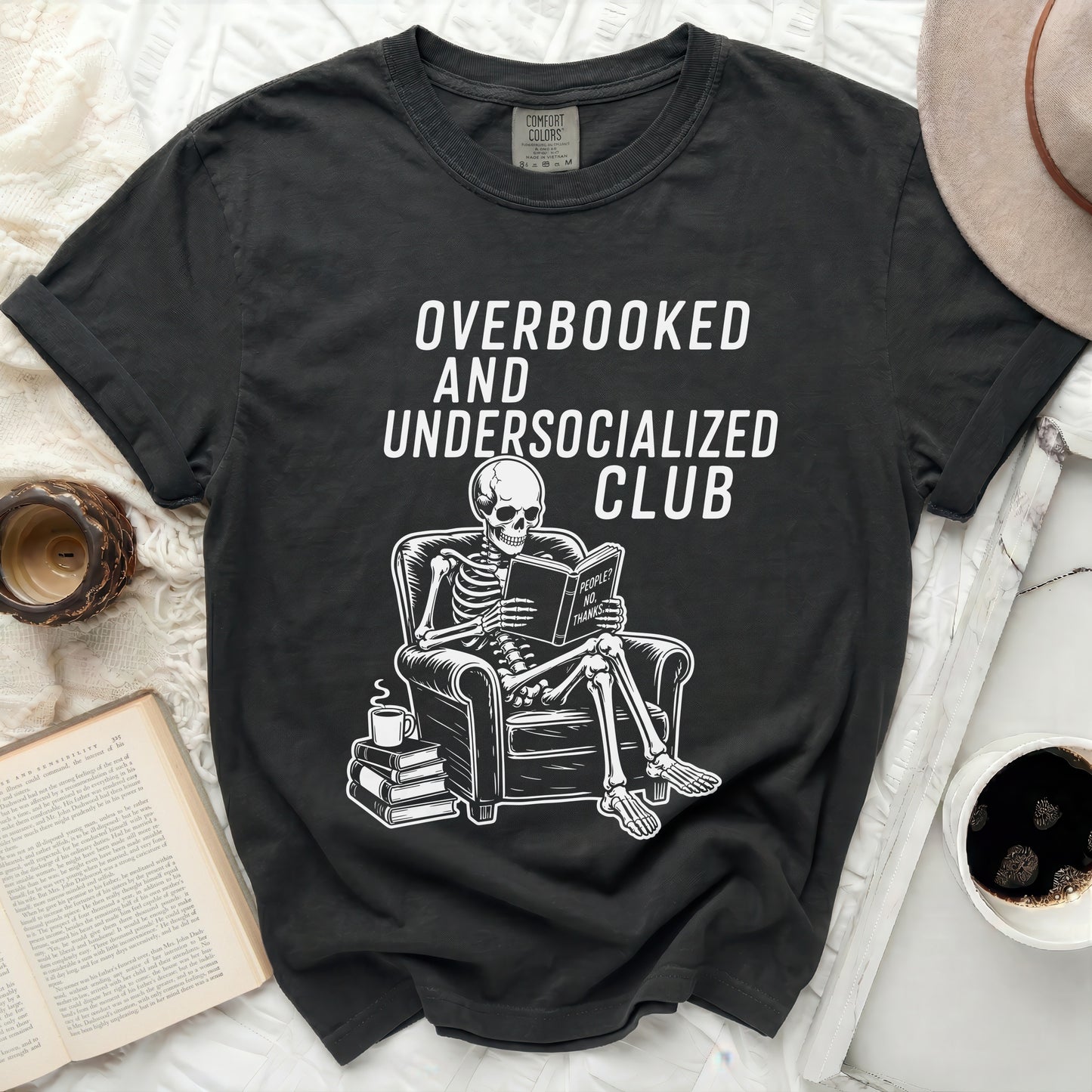 Skeleton reading book labeled "People? No, Thanks." on dark t-shirt.