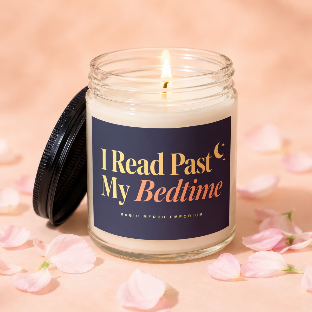 Candle with "I Read Past My Bedtime" text and a lit wick, surrounded by pink petals.