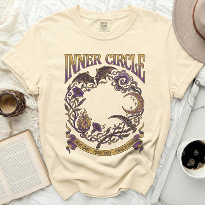 Cream t-shirt with "Inner Circle" text and a dark floral design.