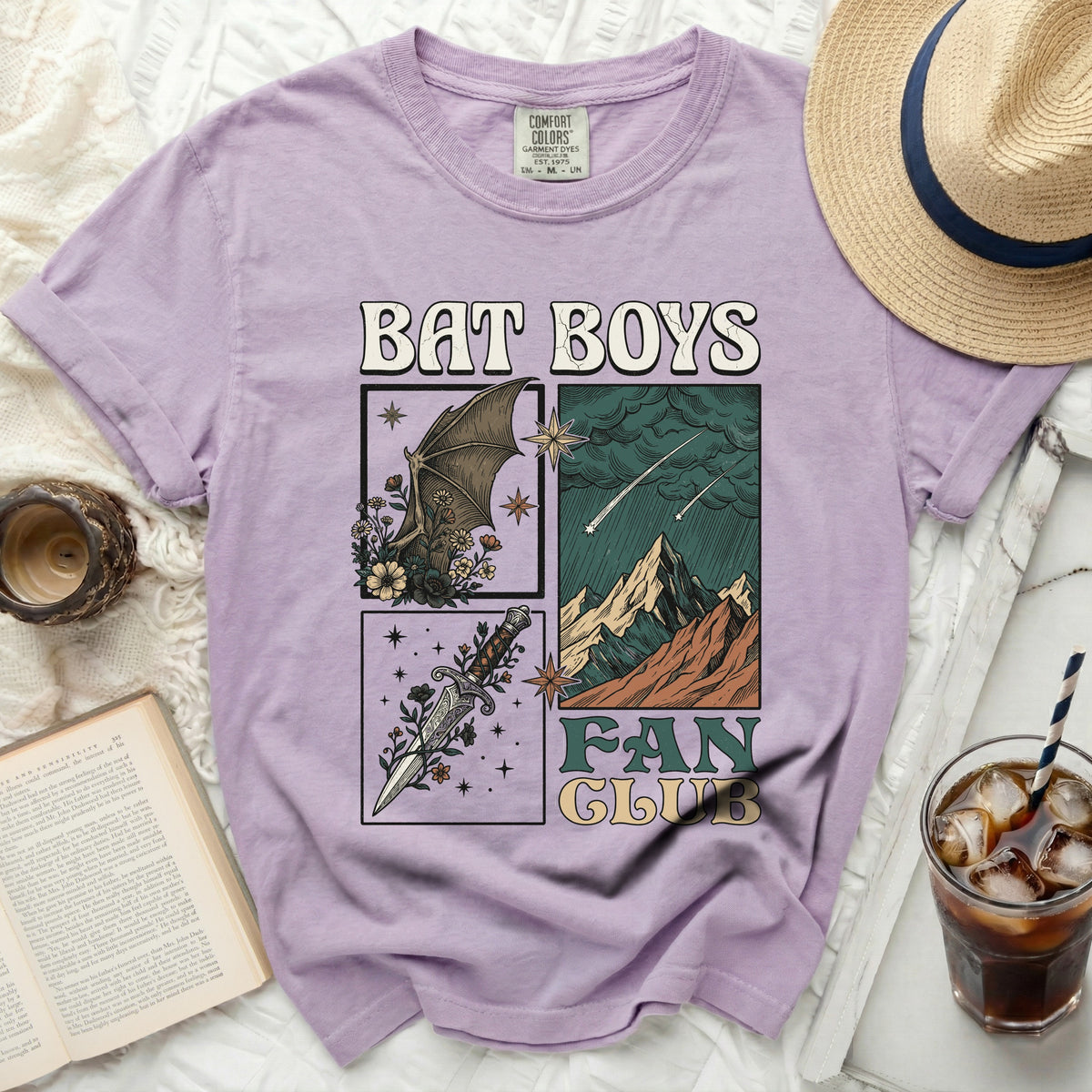 Purple t-shirt with "BAT BOYS FAN CLUB" graphic featuring bats, mountains, and dagger.