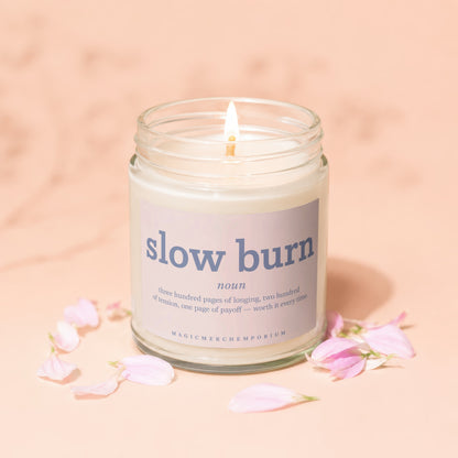 Candle with lit wick, "slow burn noun" and dictionary definition on label.