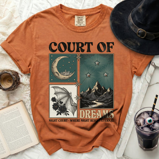 Orange t-shirt with "COURT OF DREAMS" and celestial, mountain, and bat wing graphics.