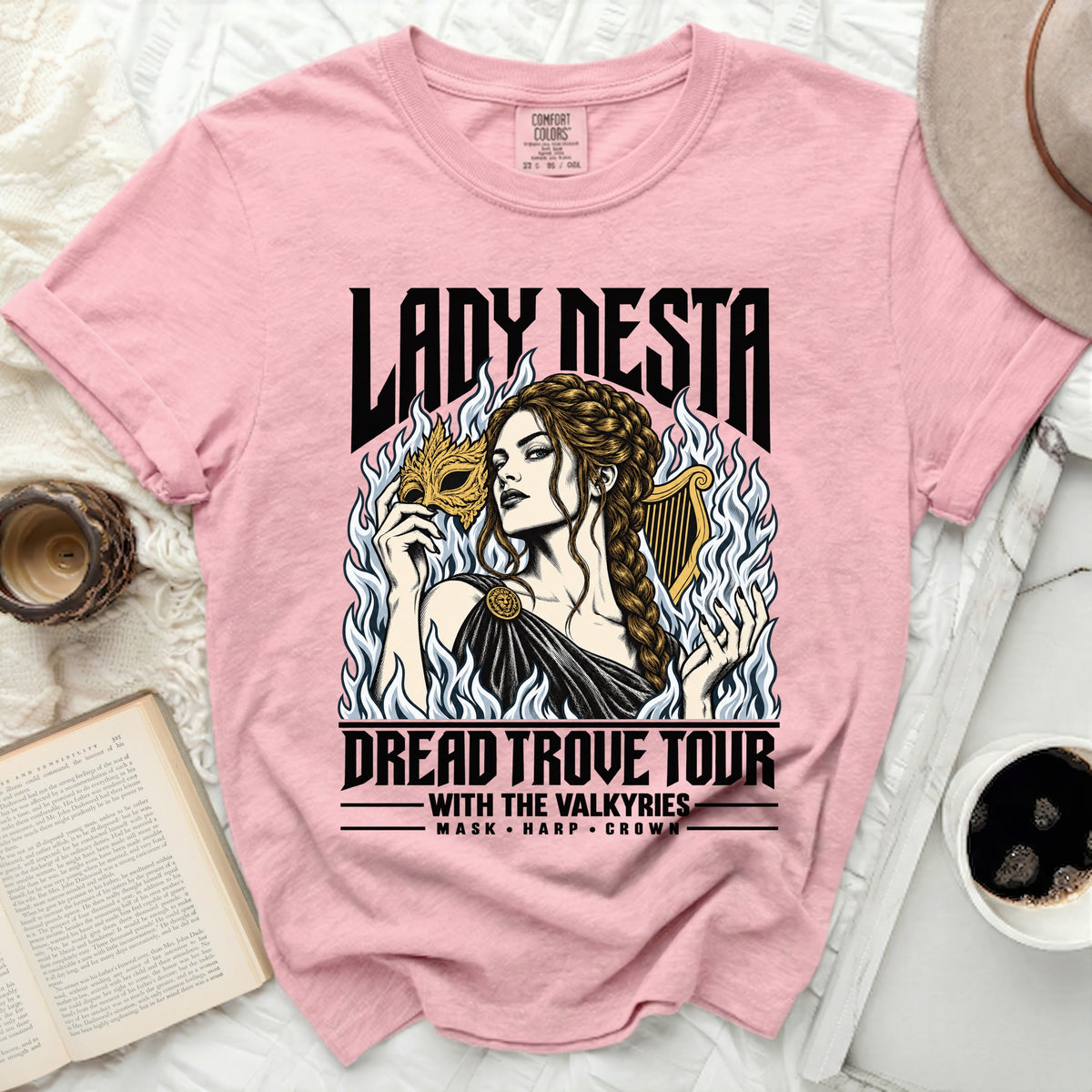 Pink t-shirt with "Lady Nesta Dread Trove Tour" graphic featuring a woman with mask and harp.