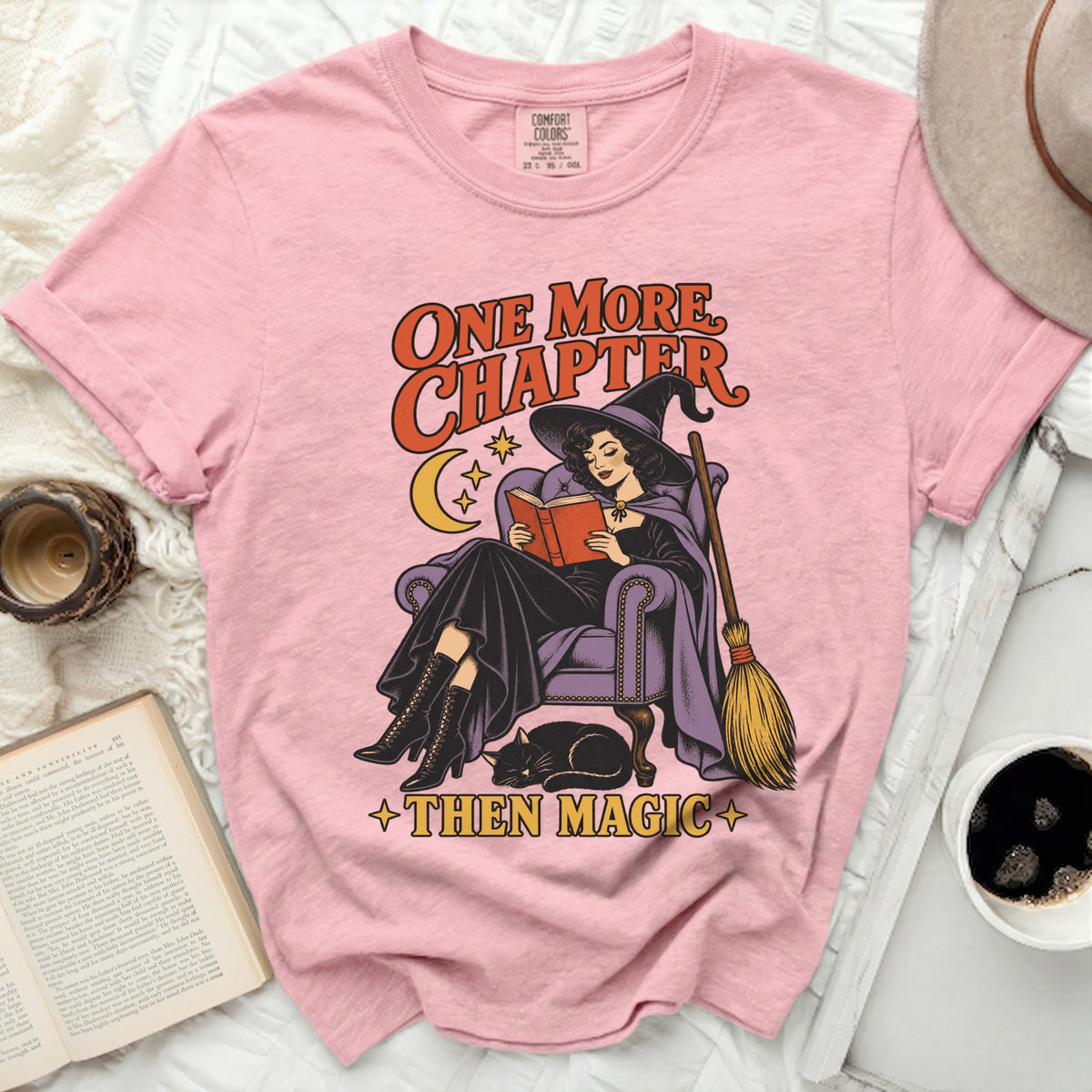 Pink t-shirt with witch reading and text "ONE MORE CHAPTER THEN MAGIC"