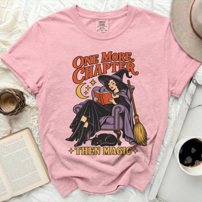 Pink t-shirt with witch reading and text "ONE MORE CHAPTER THEN MAGIC"