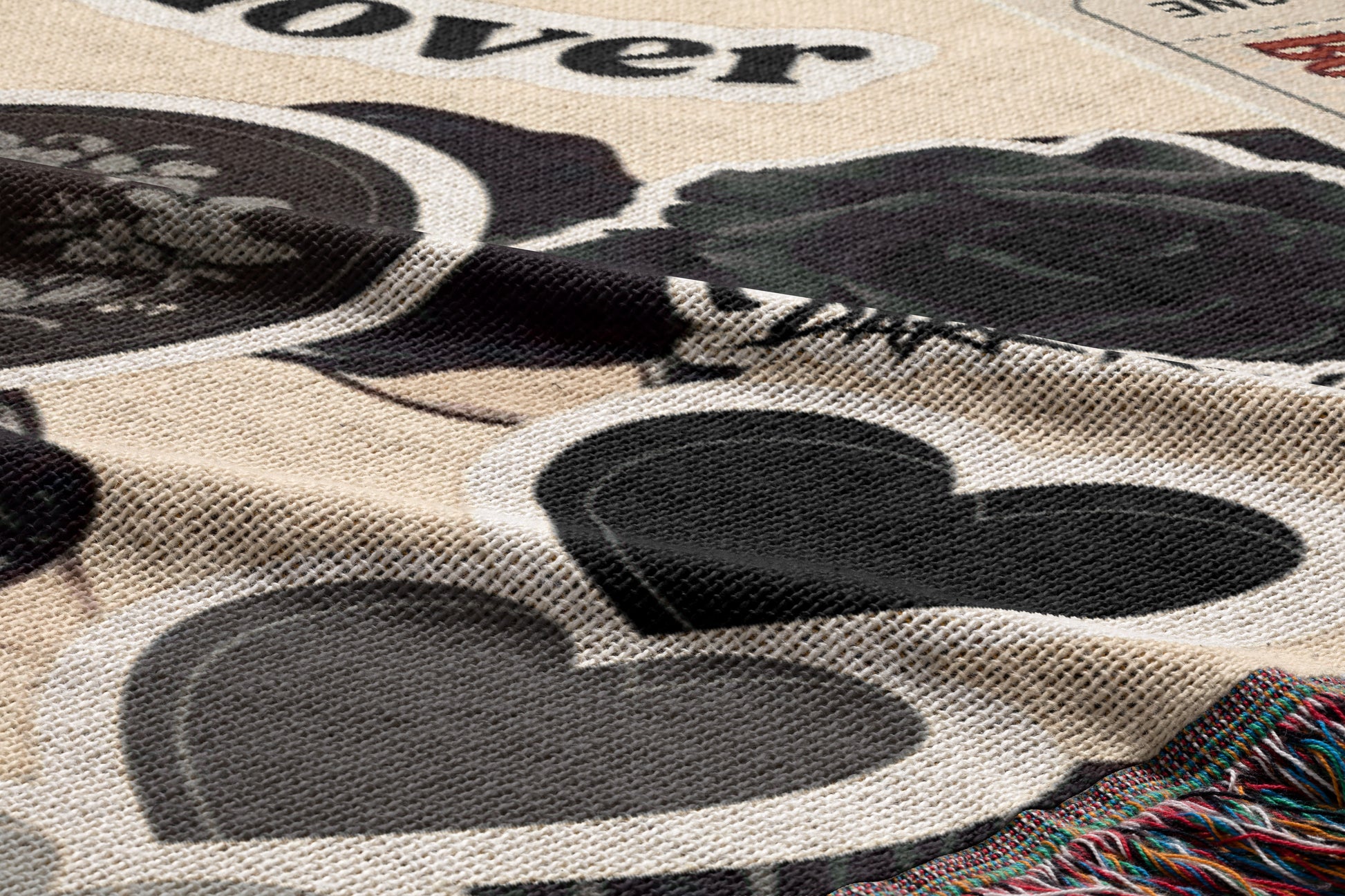 The image is a close-up of a fabric with a pattern of black and gray hearts, along with some text and other small images.