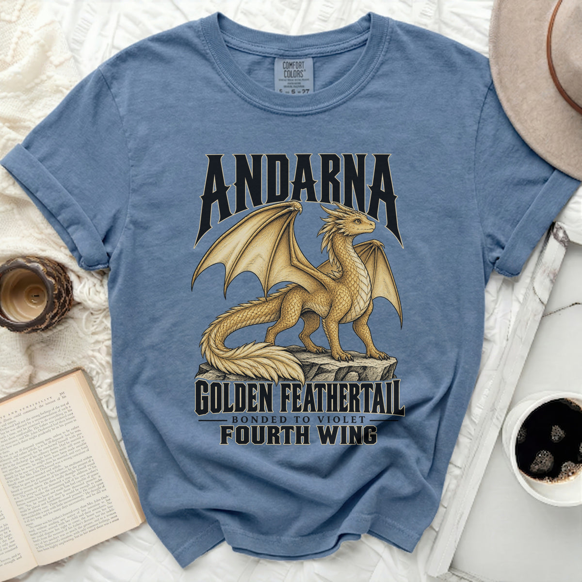 Blue t-shirt with "Andarna Golden Feathertail" dragon design.