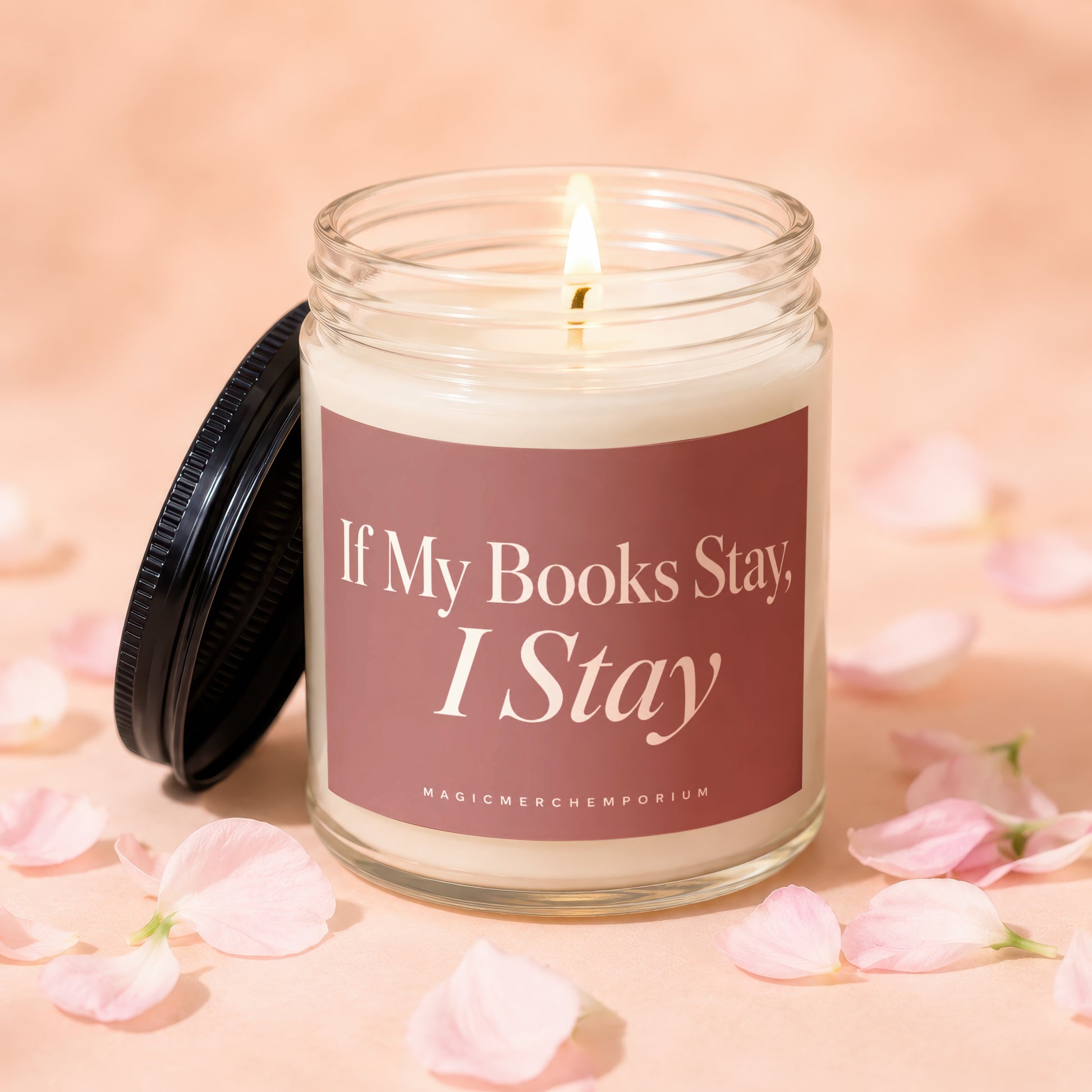 Glass jar candle with lit wick and text "If My Books Stay, I Stay".