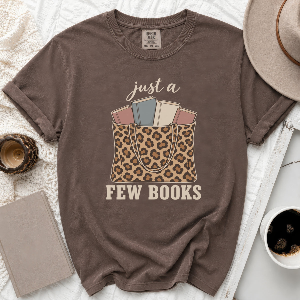 Brown t-shirt with leopard print bag graphic and "just a few books" text.