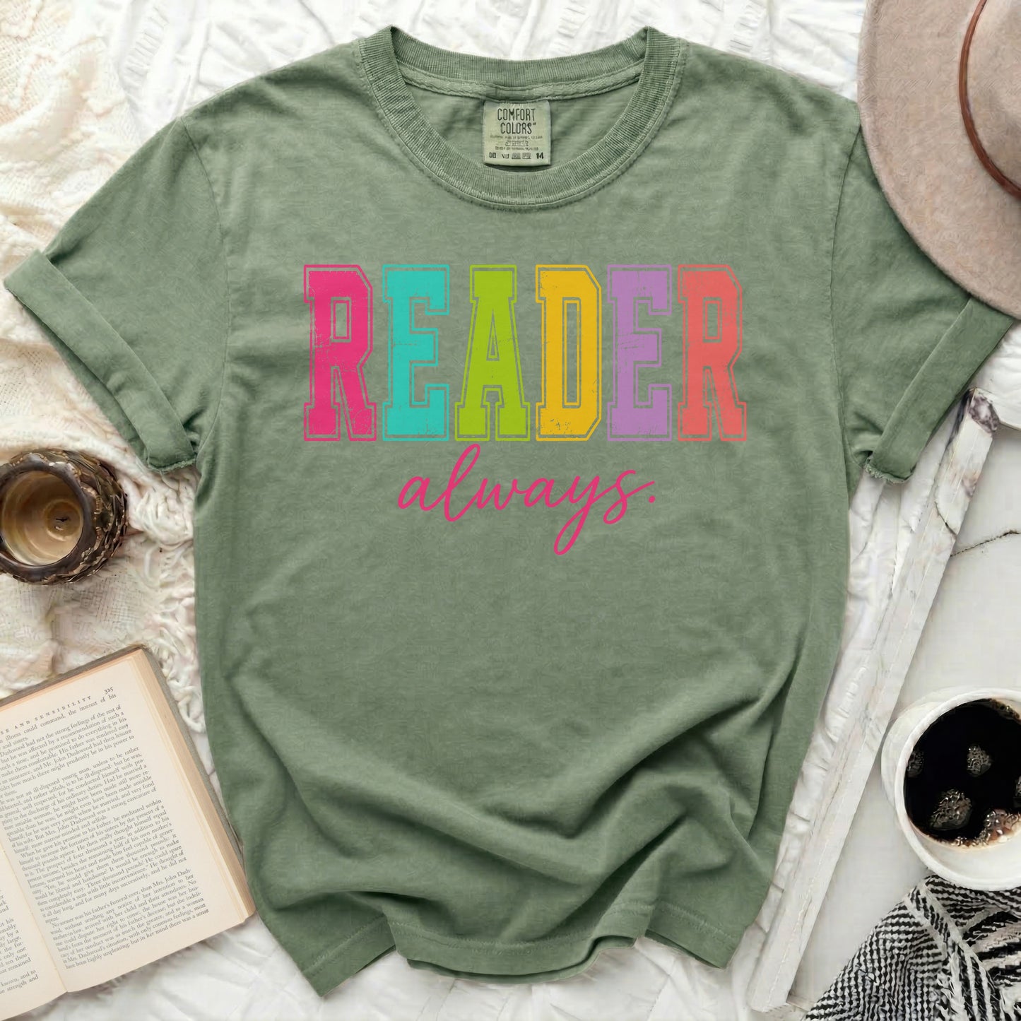 Green t-shirt with "READER always." text in colorful letters.