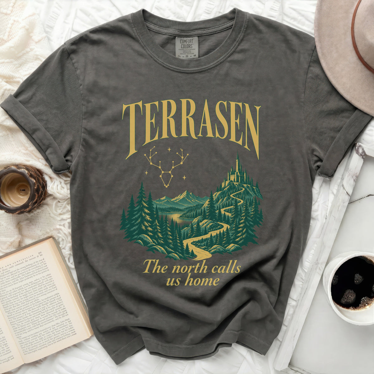 Terrasen graphic tee with forest, mountains, and castle scene, and text.