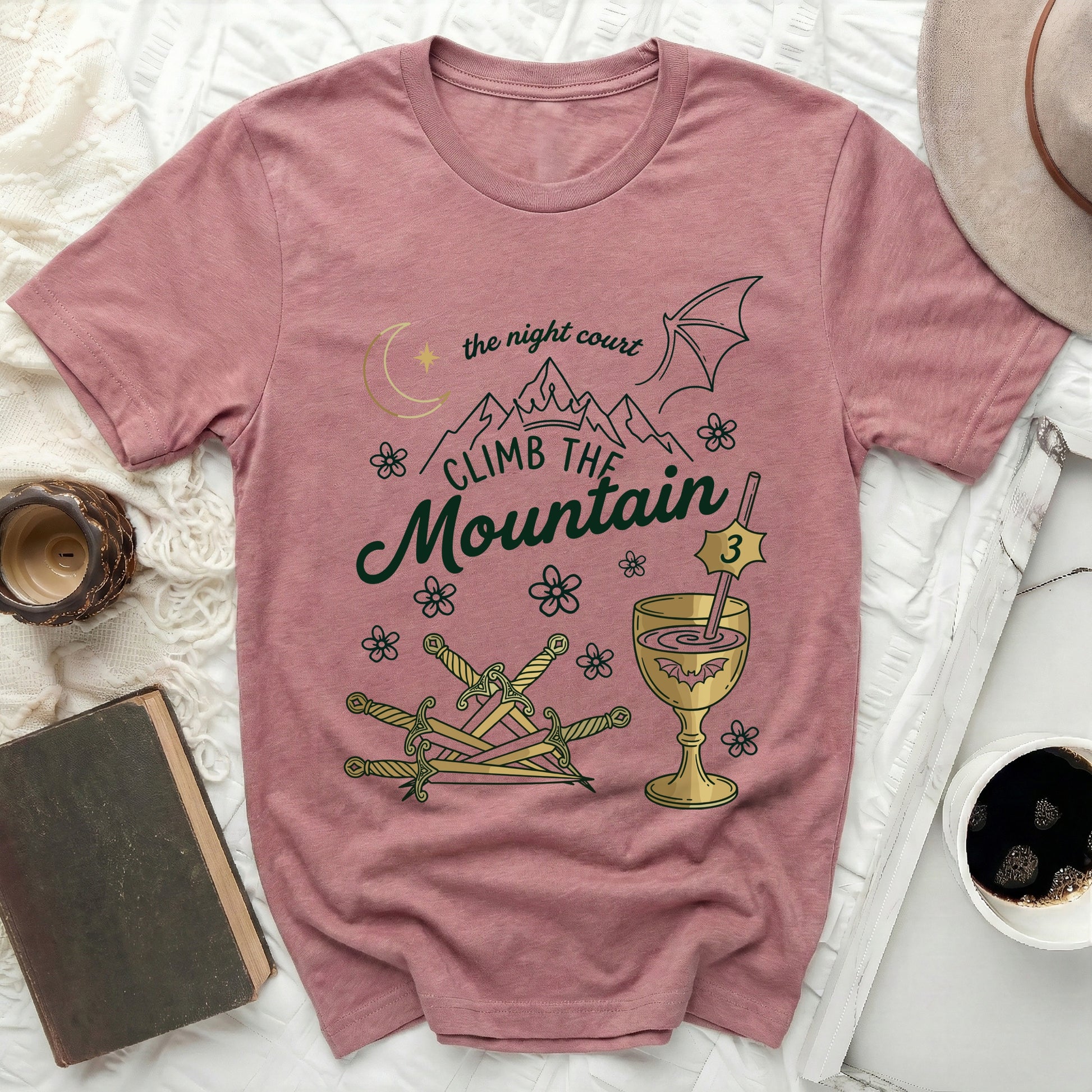 The Night Court Climb The Mountain Fantasy Graphic product type
T-shirt
Graphic Tee
Night Court
Climb Mountain
Fantasy
Book Lover
Literary
ACOTAR
Fae Realm
Moon Star
Mountains
Dragon Wing
Swords
Goblet
Bat Design
Floral Graphic
Reader Gift
Unisex Apparel
Pink Shirt
Rose Color
