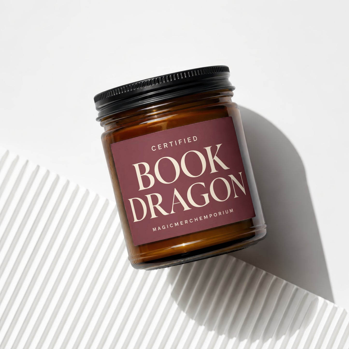 Amber jar candle titled "Certified Book Dragon" from MagicMerchEmporium.