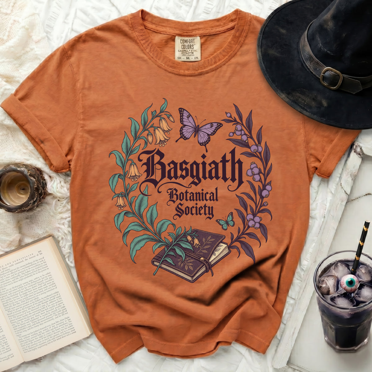 Orange t-shirt with "Basgiath Botanical Society" text and floral design.