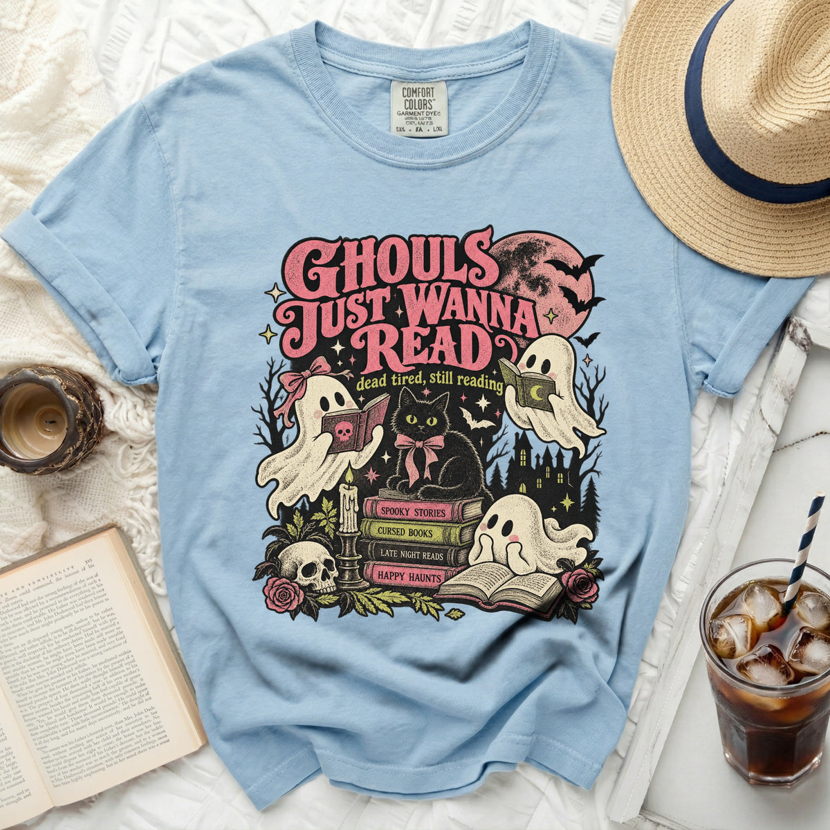 Light blue t-shirt with "Ghouls Just Wanna Read" graphic and Halloween-themed illustrations.