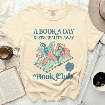 Cream t-shirt with "A Book a Day Keeps Reality Away" and "Book Club" text.