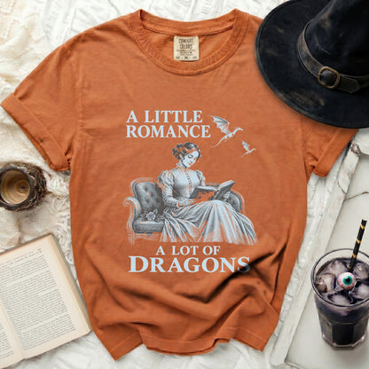 Orange t-shirt with "A Little Romance A Lot of Dragons" graphic and a woman reading.
