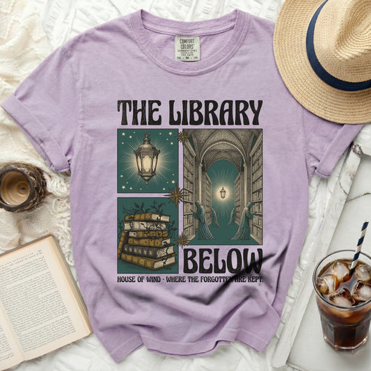 The Library Below t-shirt with illustration of books, library and text.