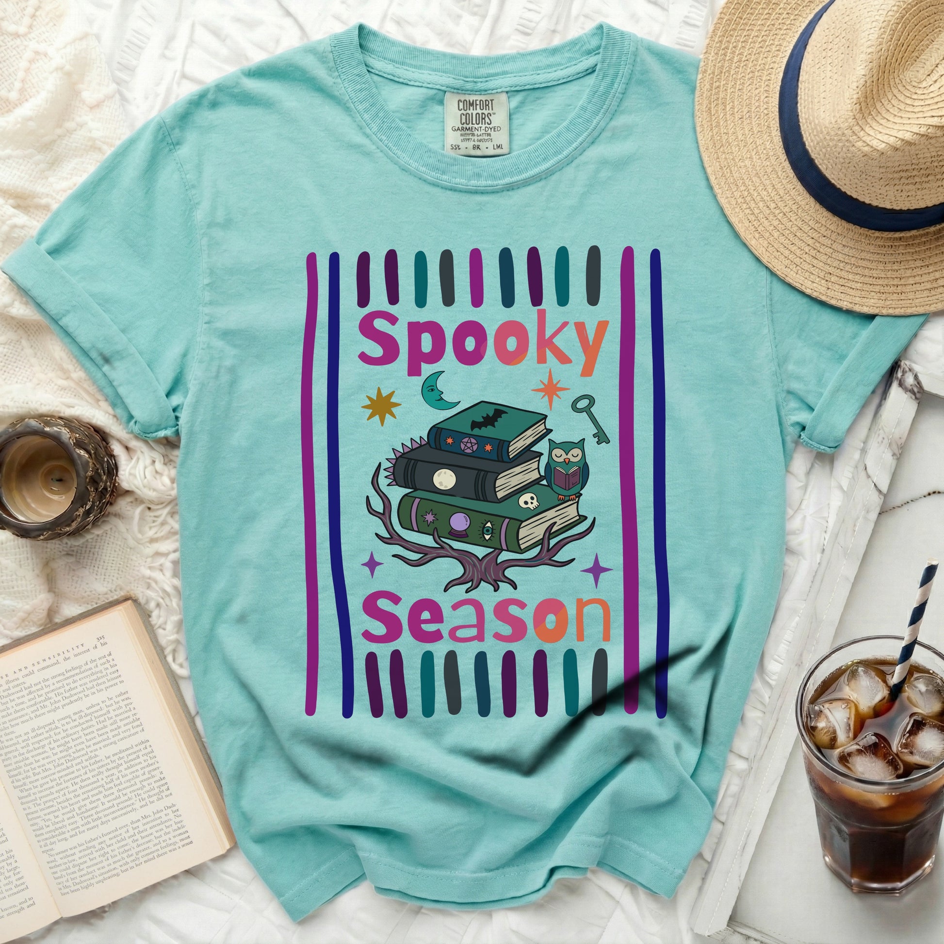 Turquoise t-shirt with "Spooky Season" Halloween graphics featuring books and owl.